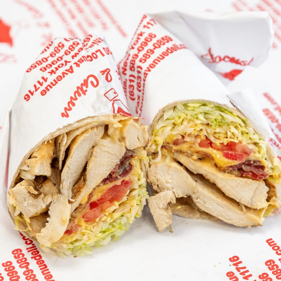 Two halves of a chicken, bacon, lettuce, tomato, and cheese wrap from Locust Avenue Deli.