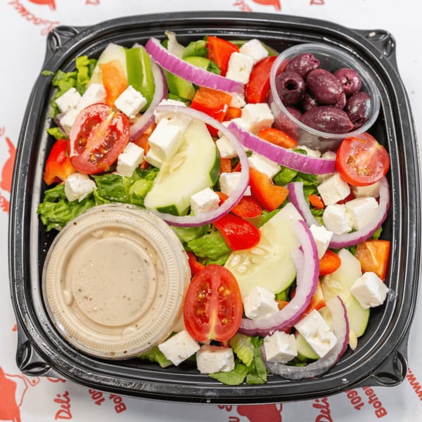 Locust Avenue Deli's Greek salad with lettuce, tomatoes, cucumbers, feta, red onion, bell peppers, and olives.