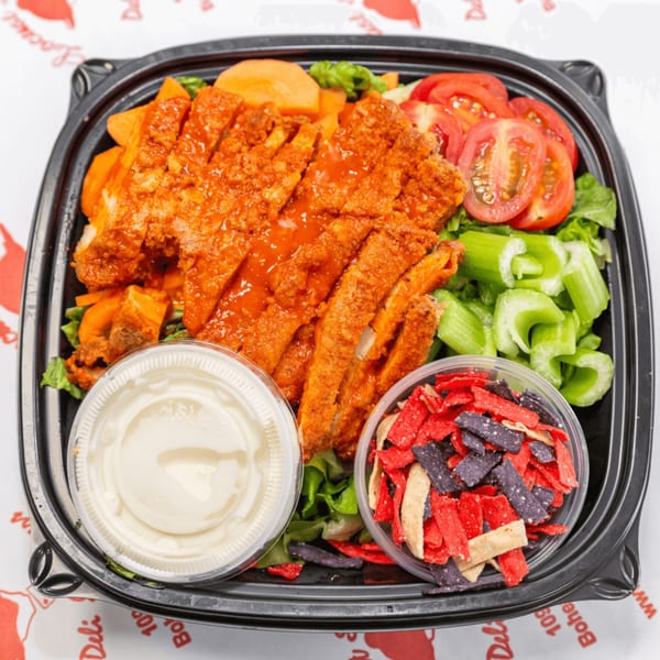 Locust Avenue Deli's buffalo chicken salad with tomatoes, celery, carrots, dressing, and tortilla strips.